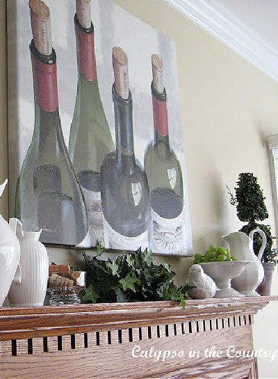 Wine bottle artwork over fireplace mantel - wine country style