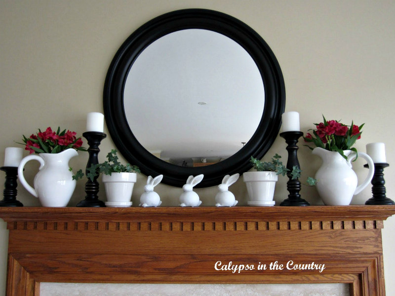 spring mantel with round mirror above - simple spring mantel with bunnies and flowers