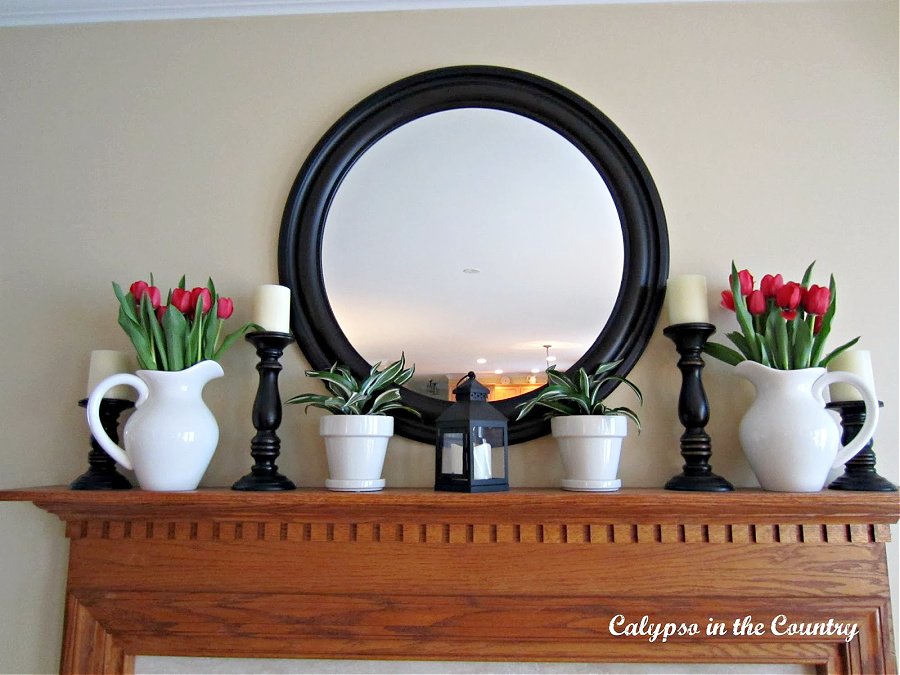 Simple spring mantel with tulips and round mirror