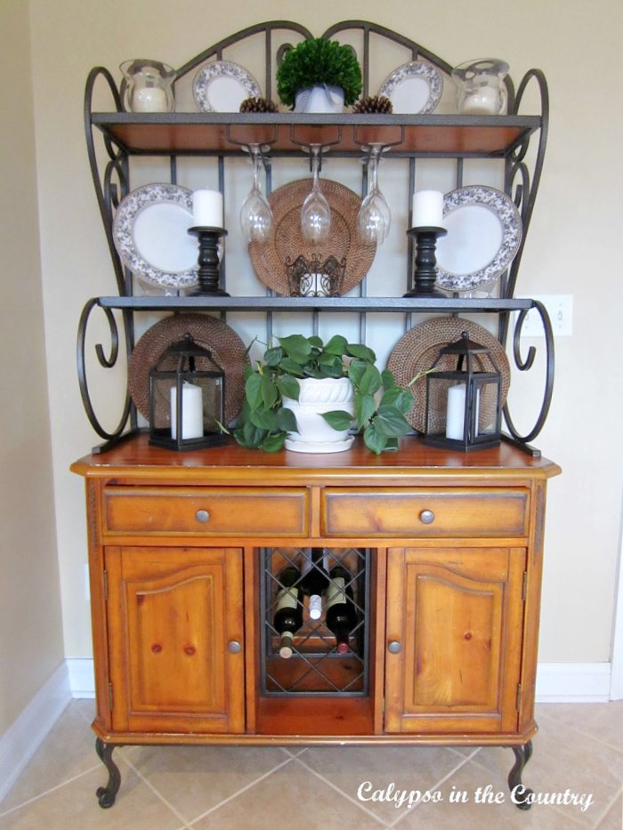 kitchen bakers rack with wood cabinet and metal scroll shelves