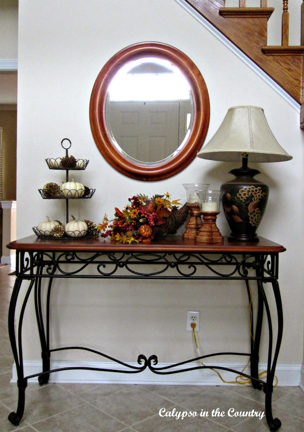 foyer table with white pumpkins