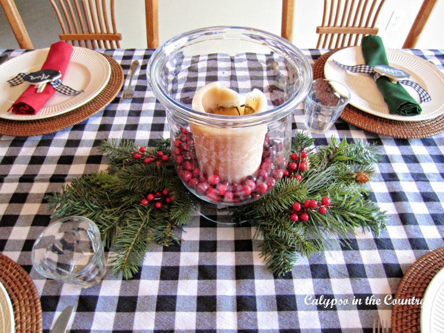 Candle centerpiece on black and white checked tablecloth - christmas breakfast ideas