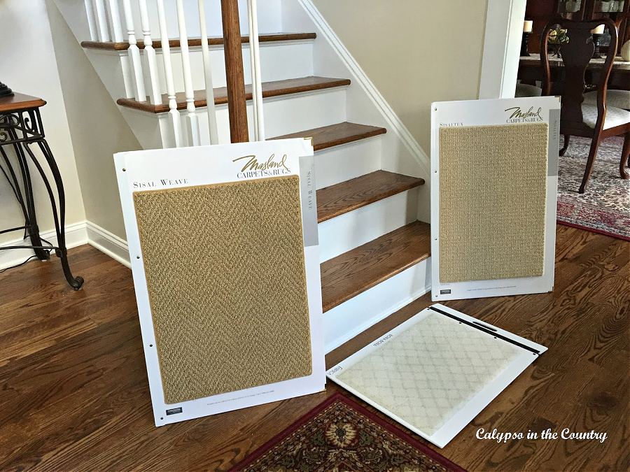 Tan rug samples in front of staircase