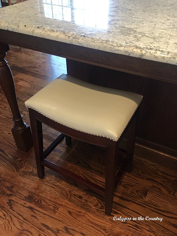 White leather counter stool under kitchen island