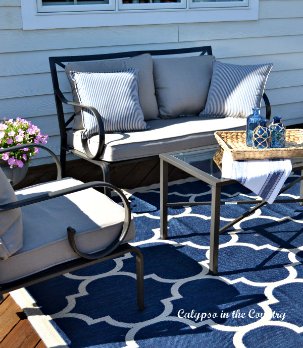 Outdoor furniture and blue rug