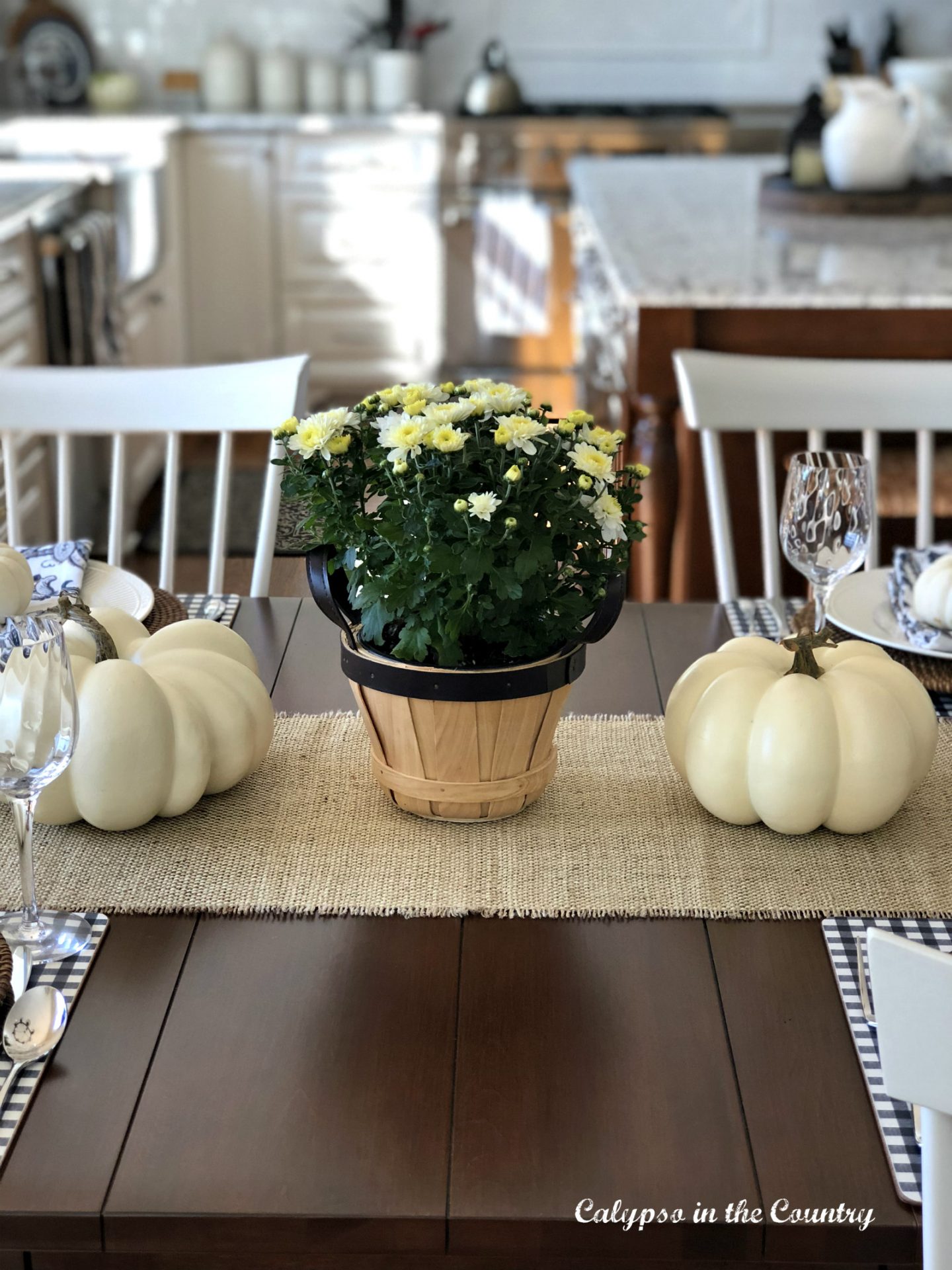 Farmhouse style kitchen table decorated for fall