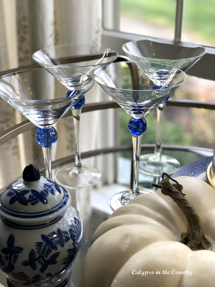 Dining Room Bar Cart Styled for fall with blue and white martini glasses
