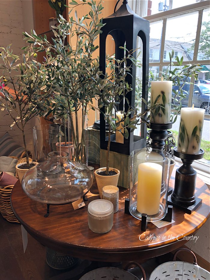 Candles and plants on round table - shopping in the Hamptons