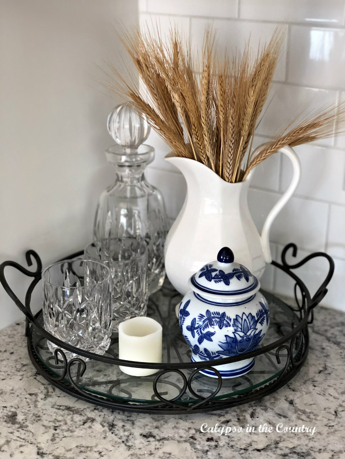 White pitcher with wheat for fall.