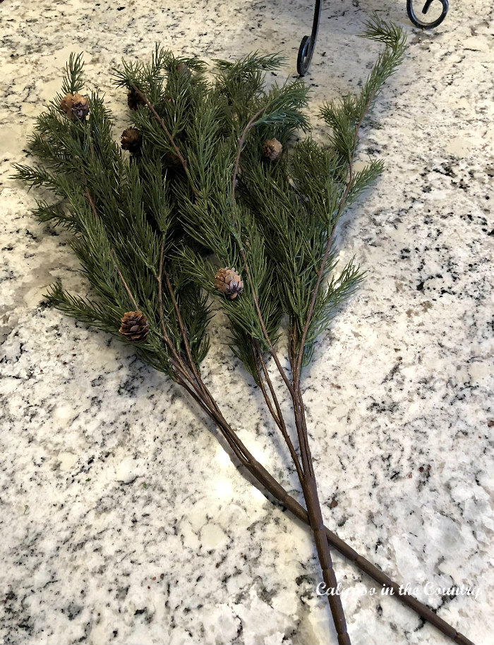 bunches of faux greens - Easy Way to Decorate a chandelier for Christmas
