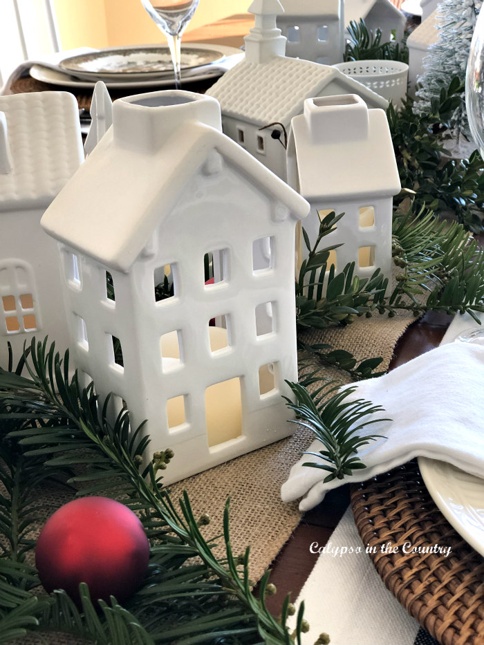 White ceramic houses on Christmas table
