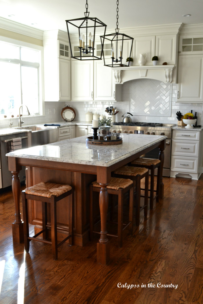 White kitchen with brown cherry island