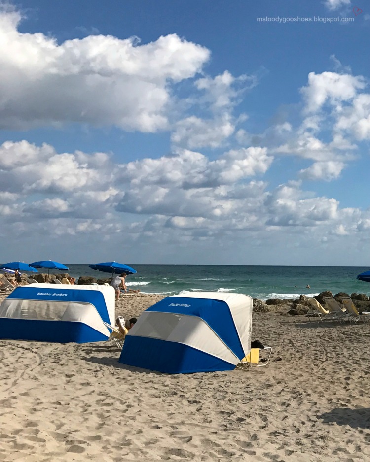 Blue and white cabanas on beach