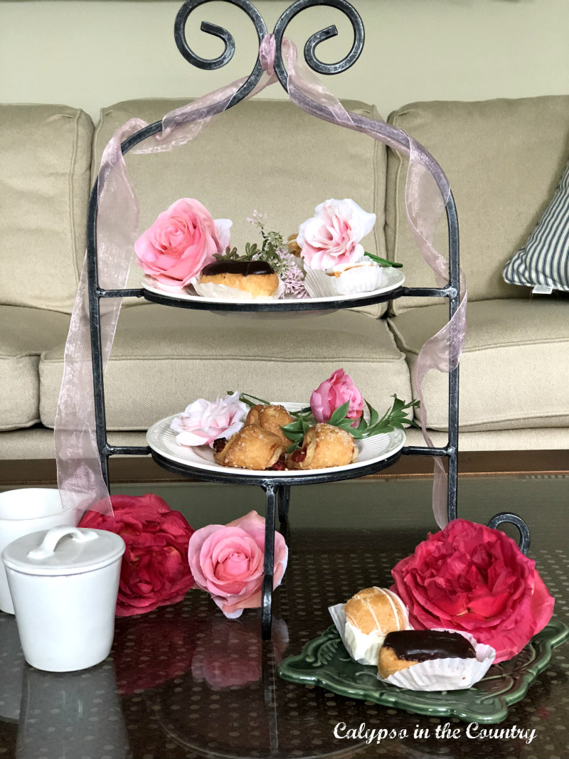 tiered tray with tea snacks and pink flowers 