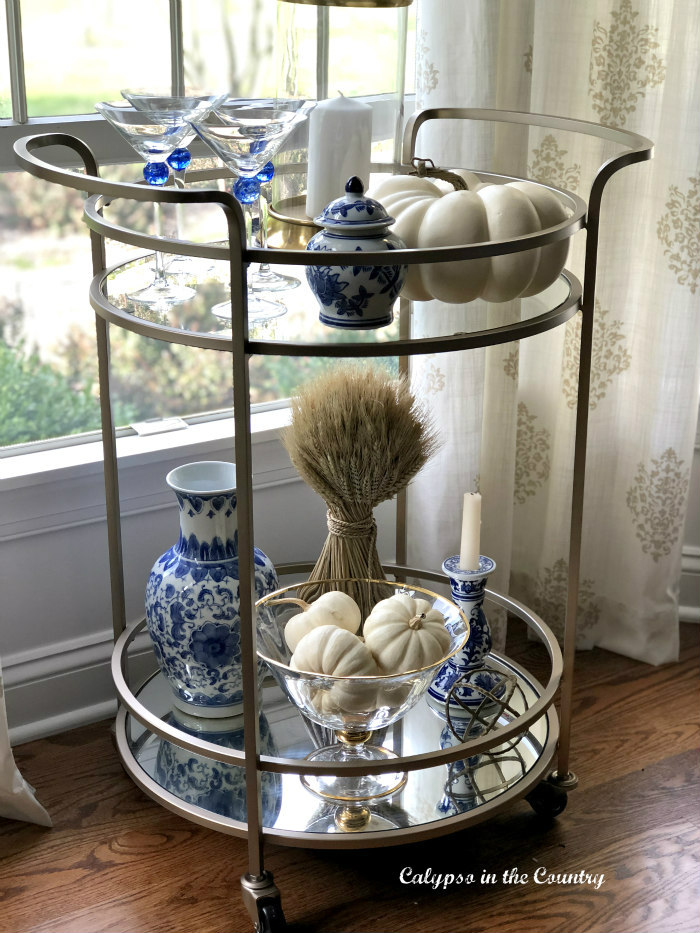 blue and white accessories on bar cart