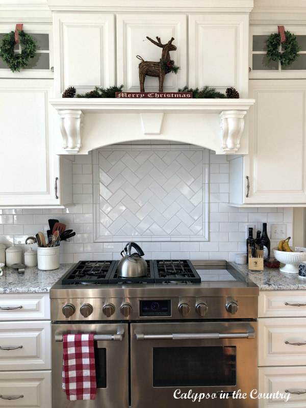 white stove mantel decorated in a rustic farmhouse style for Christmas