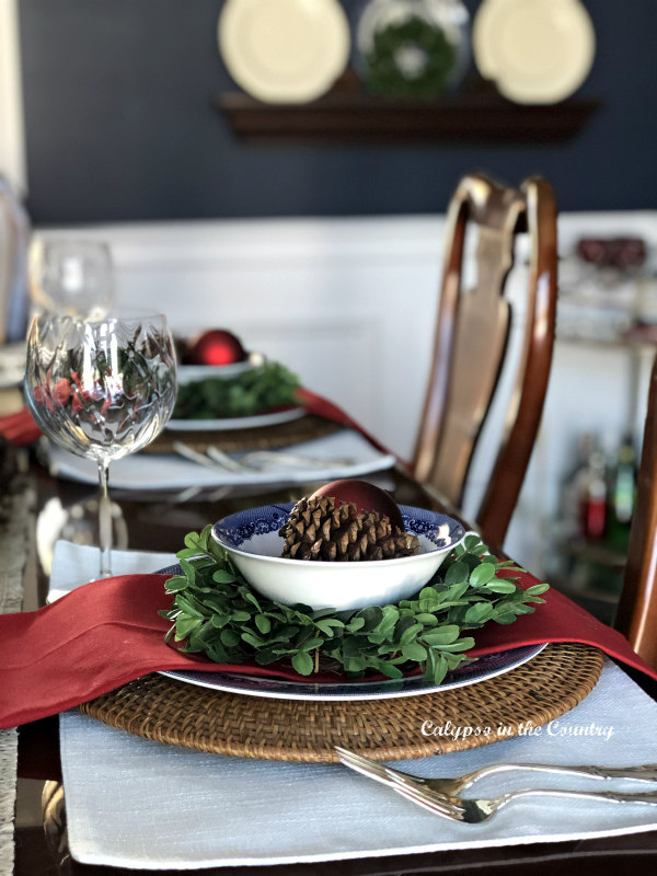 Christmas place settings in a navy dining room