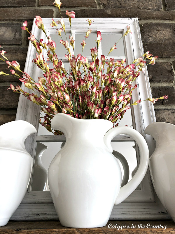 White farmhouse pitcher with flowers on mantel - spring decorations for mantels