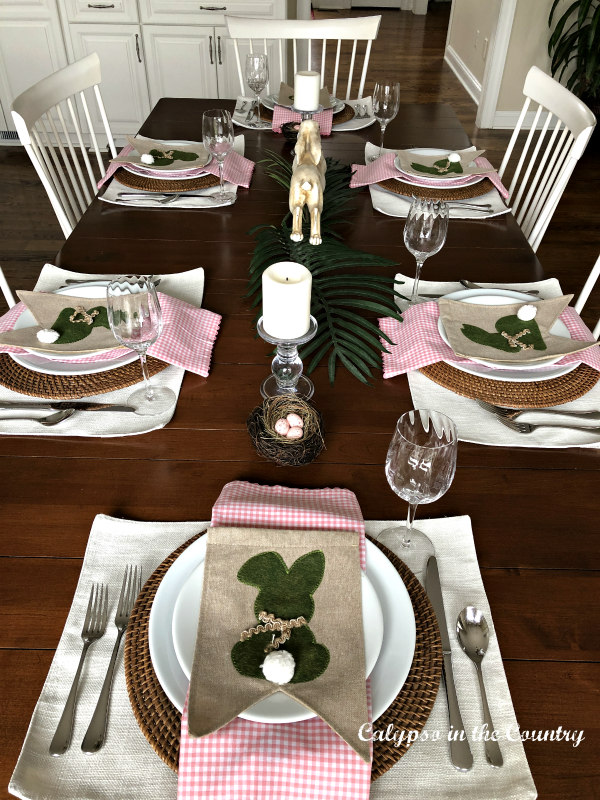 simple Easter tablescape with bunnies and palm leaves