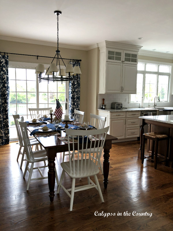 White kitchen with blue and white curtains with patriotic decor