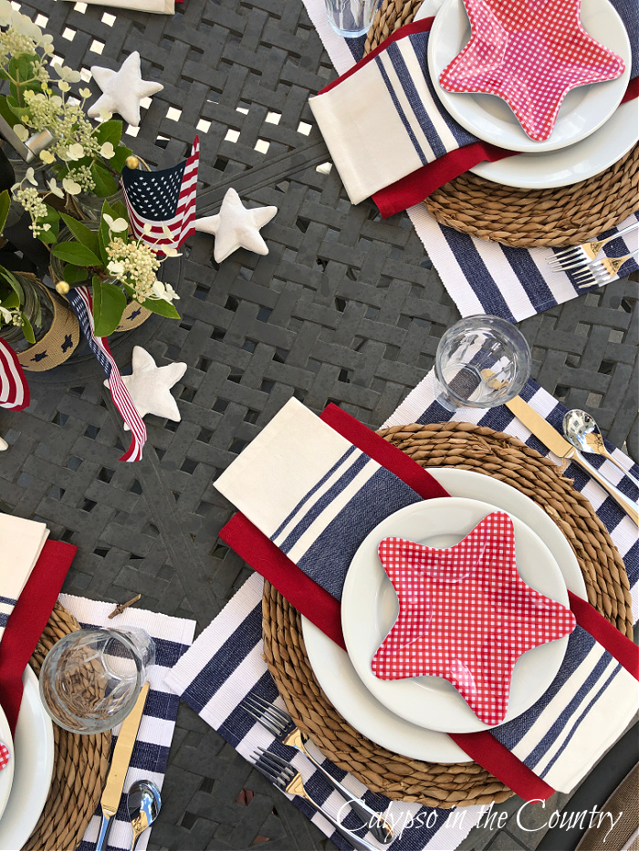 Top view of patriotic tablescape on patio with red white and blue items