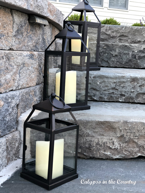 Lanterns on stone patio stairs - summer nights entertaining on the patio