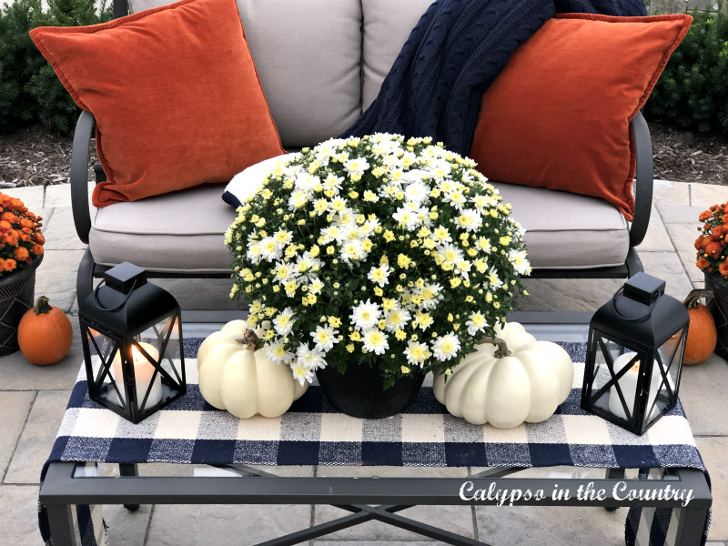 Mums and pumpkins on patio coffee table - easy fall outdoor decorating ideas