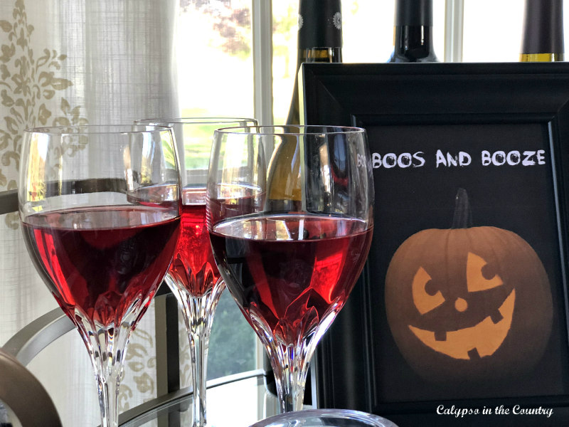 Red wine in glasses with Jack-o-lantern sign