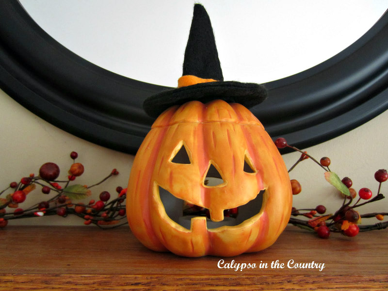 Orange jack-o-lantern on mantel - cute Halloween ideas