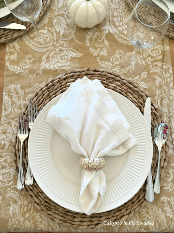 White plate and napkin on neutral fall table