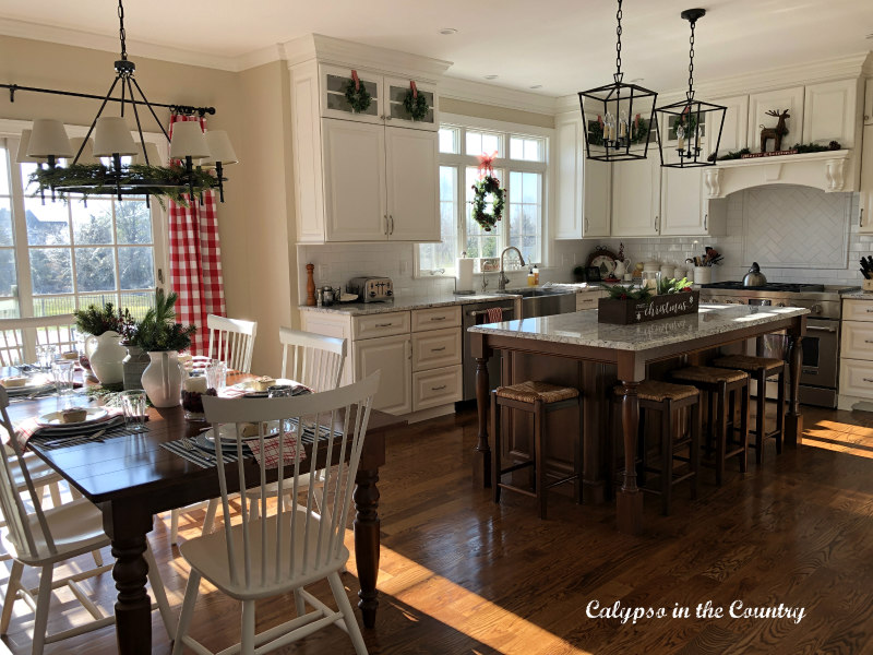 White kitchen decorated with red for Christmas