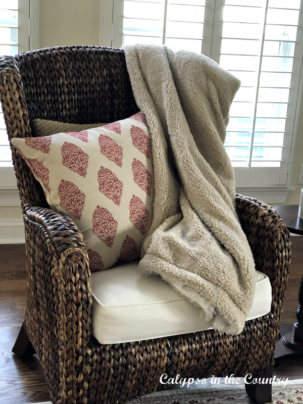 cozy sherpa blanket on seagrass chair - cozy shopping finds