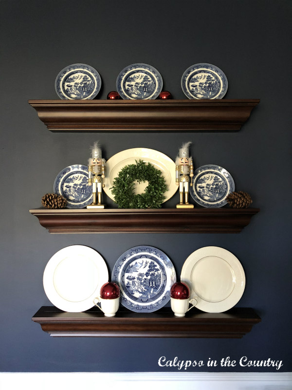 3 wall ledge shelves with dishes and Christmas ornaments