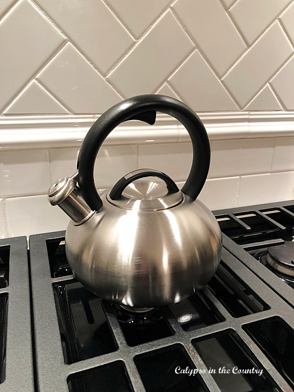 Stainless steel tea kettle on stove - one of our favorite kitchen items