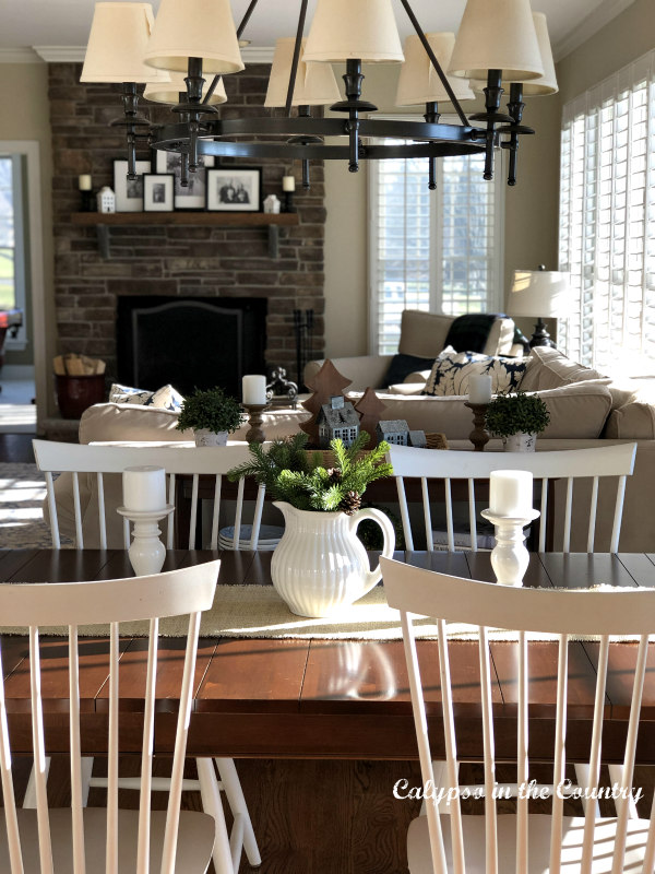 White farmhouse style chairs with winter white centerpiece on table