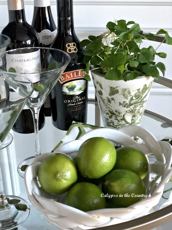 Green limes and accessories on bar cart