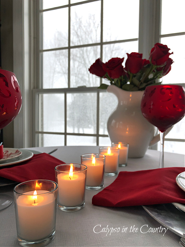 Candles and Red Roses on Valentine Table