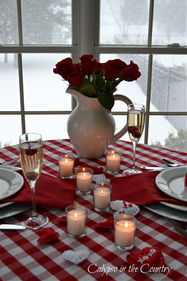 Red and white buffalo checked tablecloth with candles