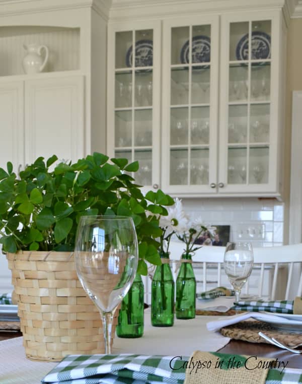 Green and White Table Setting with Glass Cabinets - ways to celebrate St. Patrick's Day