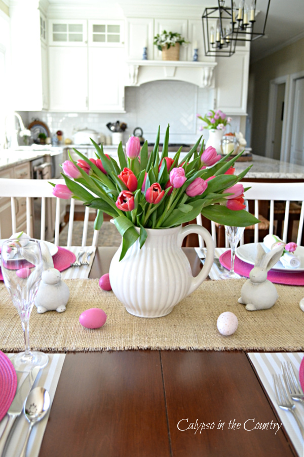 Pink tulips in white pitcher