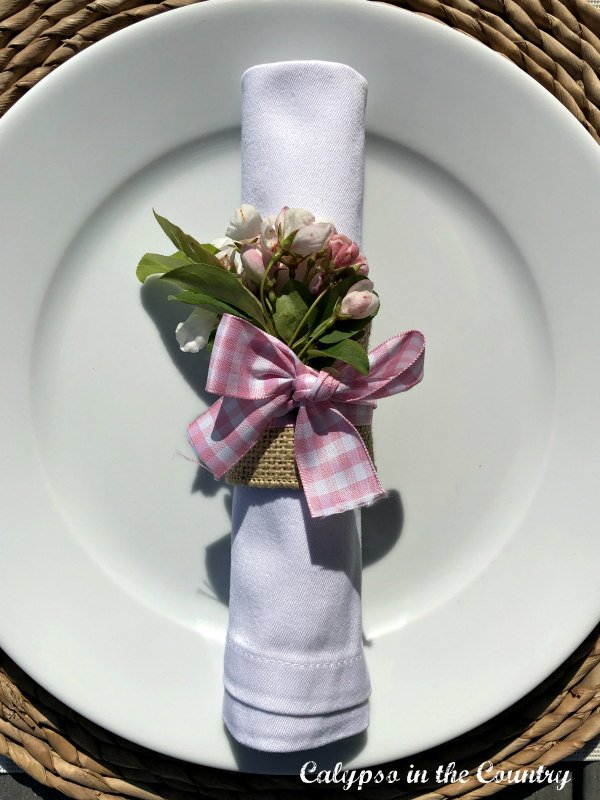 Pink gingham ribbon tied around a DIY napkin ring - Buffalo check home decor