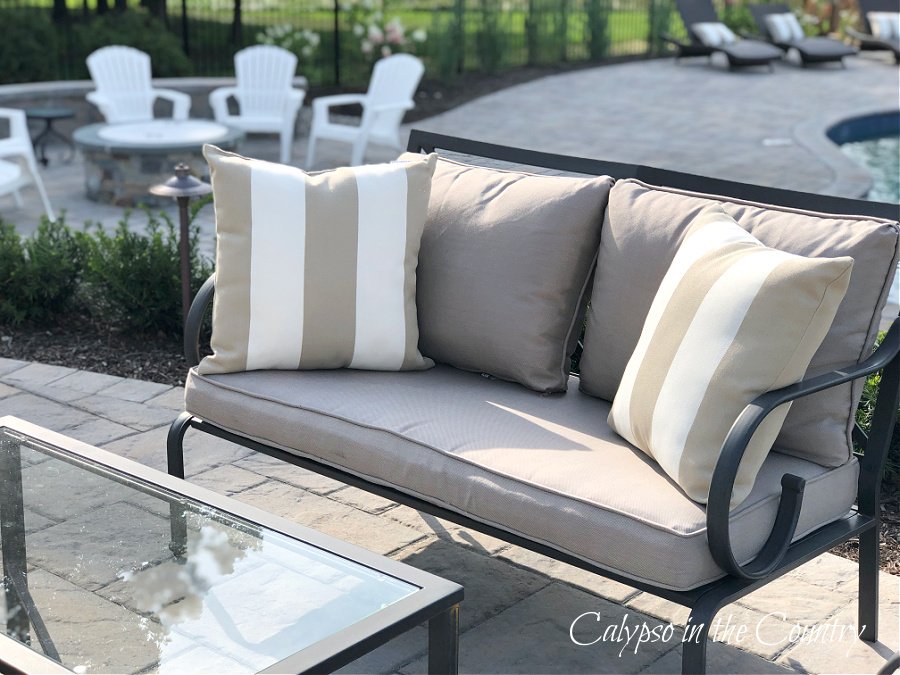 Patio sofa with striped pillows - outdoor entertaining area