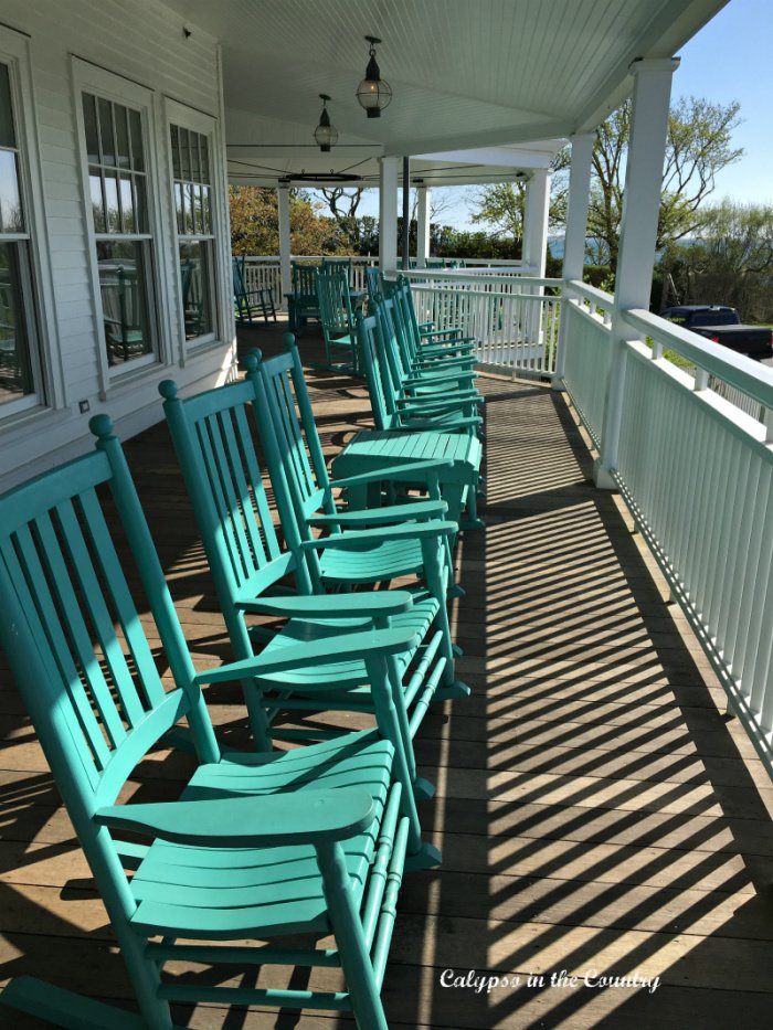 Row of turquoise rocking chairs on porch - outdoor entertaining area ideas