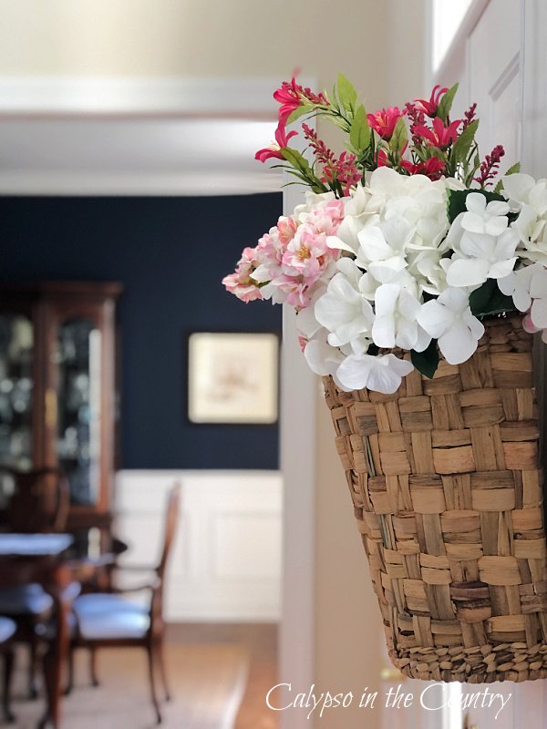 Basket of flowers hanging on inside of door - Spring entryway ideas 