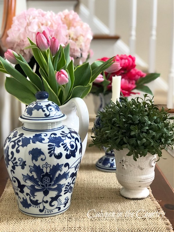 Blue and white porcelain and flowers on table - how to decorate an entry table for spring