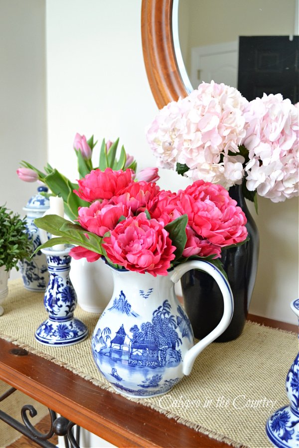 Foyer table with pink flowers and blue and white porcelain