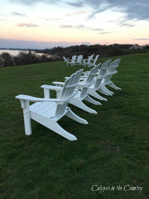 White Adirondack Chairs at sunset - best summer road trips