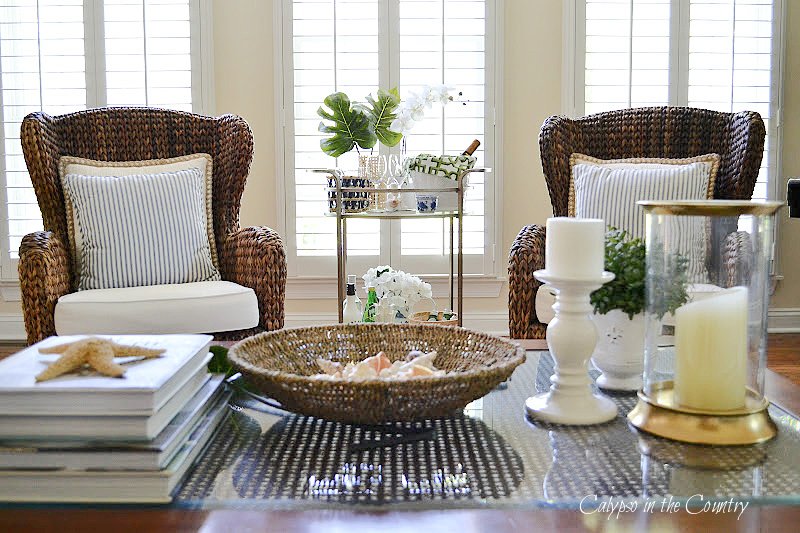 Cane coffee table and seagrass chairs with tropical bar cart styling tips