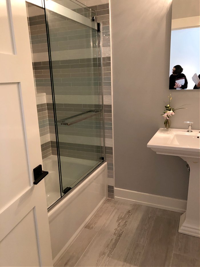 gray bathroom with striped shower tile