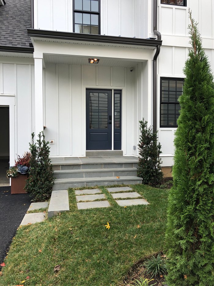 white modern farmhouse back porch with black door - home design ideas